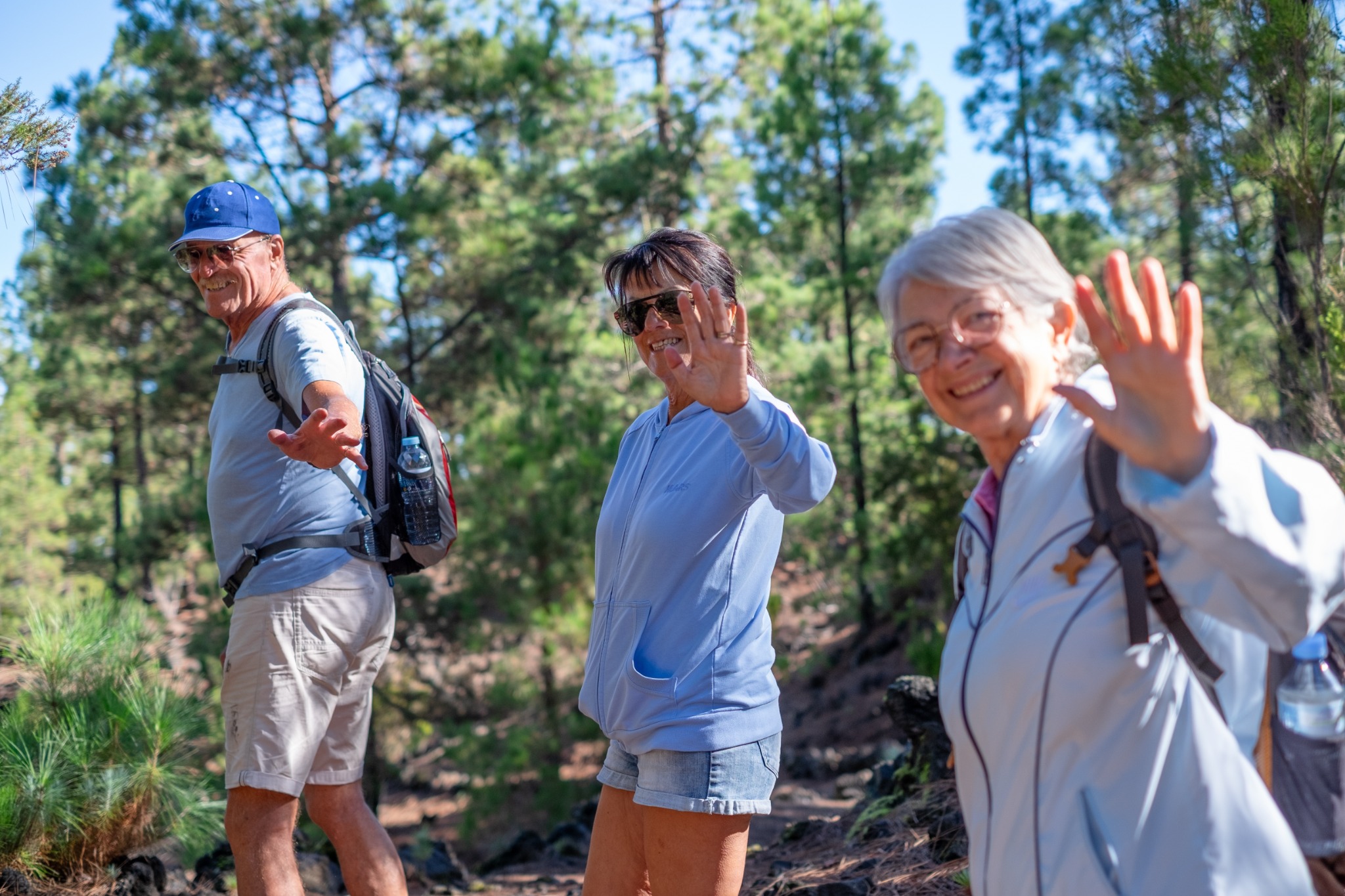 Three older adults enjoying a hike together